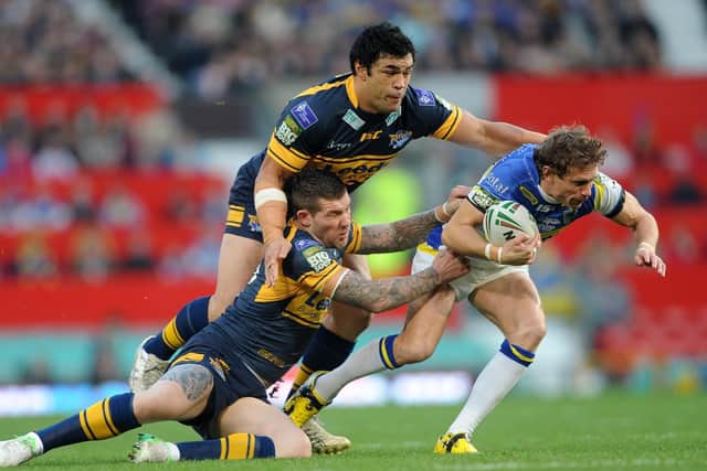 Brett Delaney and Kylie Leuluai tackle Warrington's Brett Hodgson - who is now coach of Hull - at Wembley in 2012. Picture by Steve Riding.
