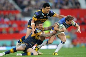 Brett Delaney and Kylie Leuluai tackle Warrington's Brett Hodgson - who is now coach of Hull - at Wembley in 2012. Picture by Steve Riding.