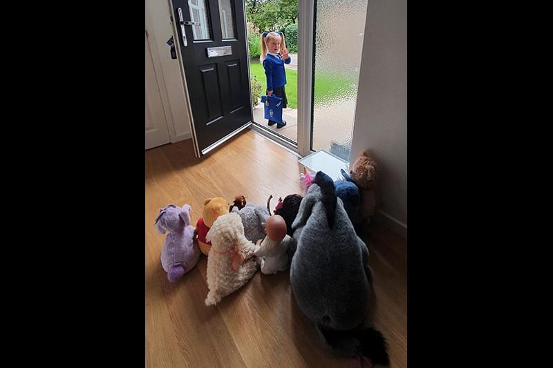 Erin, age 4, waving to her toys as she heads off for her first day at school. Picture: Jen Bramall
