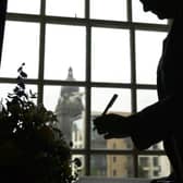 A member of the public signs the book of condolence at Leeds Civic Hall.