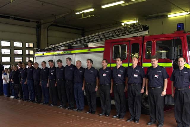 Firefighters and support staff at Leeds Fire Station observe a minutes silence.
