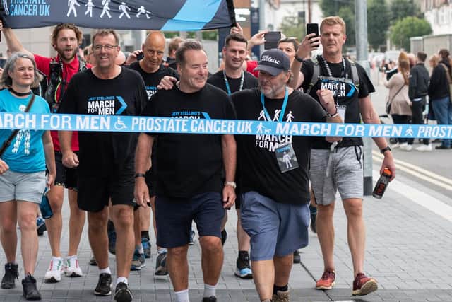 Jeff Stelling, joined by 200 football fans, crosses the finish line
