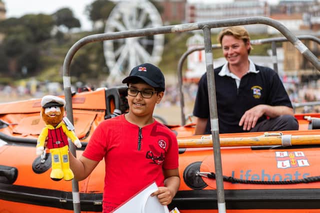 Ravi Saini with lifeboat crewman Rudi Barman, during a visit to Scarborough lifeboat station to thank them.