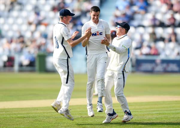 CAREER-BEST: Yorkshire's Matt Fisher celebrates the wicket of Somersets Azhar Ali with team-mates George Hill and Dom Bess Picture by Will Palmer/SWpix.com