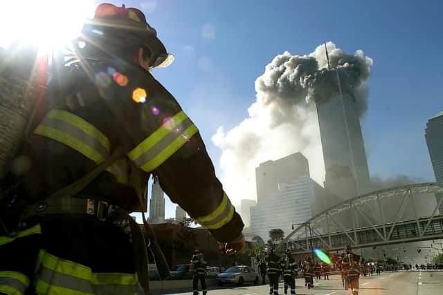 Firefighters walk towards one of the tower at the World Trade Center before it collapsed after a plane hit the building September 11, 2001 in New York City. (Photo by Jose Jimenez/Primera Hora/Getty Images).