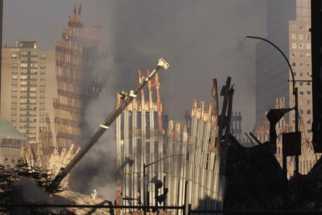 Bruce Rollinson's photograph of the skeletal remains of the World Trade Centre seen through dust and smoke at Ground Zero as seen from lower Broadway. September 19, 2001.