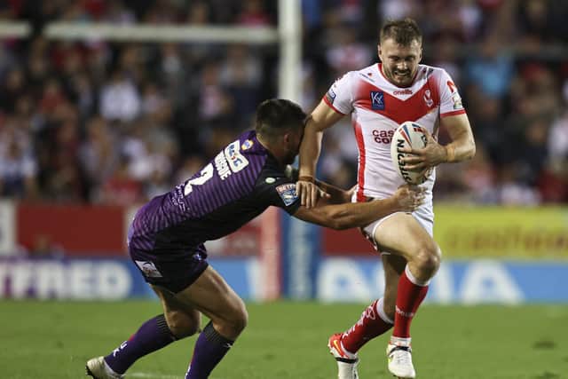 Held :Leeds Rhinos' Tom Briscoe tackles St Helens' Joe Batchelor. Picture by Paul Currie/SWpix.com