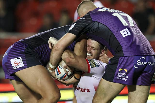 Tight grip: St Helens' Lachlan Coote is tackled by Leeds Rhinos' Sam Walters and Cameron Smith. Picture by Paul Currie/SWpix.com