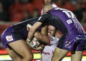 Tight grip: St Helens' Lachlan Coote is tackled by Leeds Rhinos' Sam Walters and Cameron Smith. Picture by Paul Currie/SWpix.com