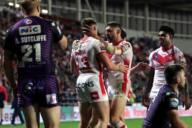 Seventh heaven: Alex Sutcliffe looks on as Morgan Knowles celebrates scoring St Helens' seventh try. Picture: Richard Sellers/PA Wire.