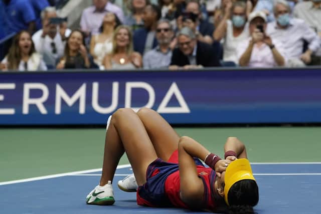 Emma Raducanu collapses to the floor after defeating Leylah Fernandez in the US Open women's singles final in New York on Saturday night. Picture: AP/Elise Amendola