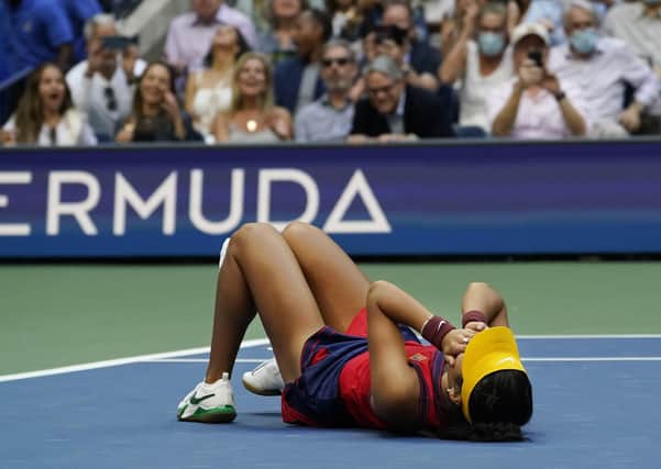 Emma Raducanu collapses to the floor after defeating Leylah Fernandez in the US Open women's singles final in New York on Saturday night. Picture: AP/Elise Amendola