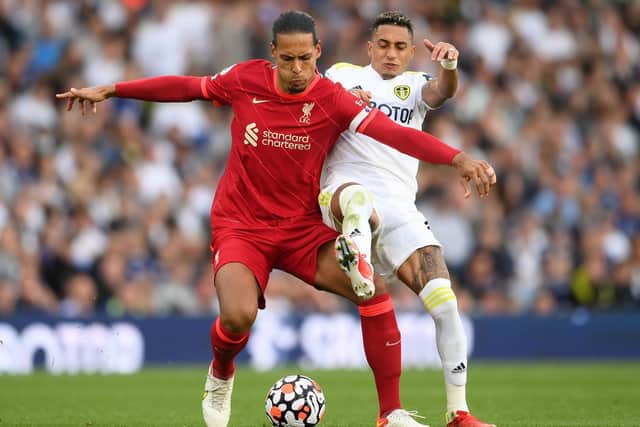 RELISHED IT: Liverpool's Virgil van Dijk, front, holds off Leeds United winger Raphinha in Sunday's 3-0 victory at Elland Road. Photo by Laurence Griffiths/Getty Images.