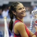 Emma Raducanu holds the trophy as she celebrates winning the women's singles final. PIC: PA