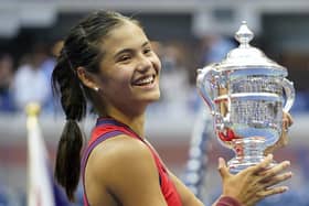 Emma Raducanu holds the trophy as she celebrates winning the women's singles final. PIC: PA