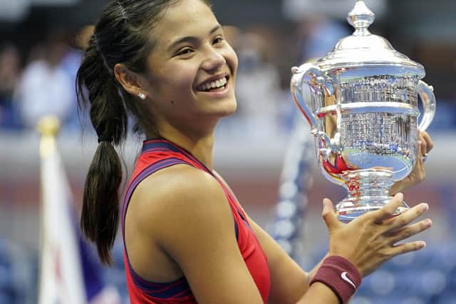 Emma Raducanu holds the trophy as she celebrates winning the women's singles final. PIC: PA