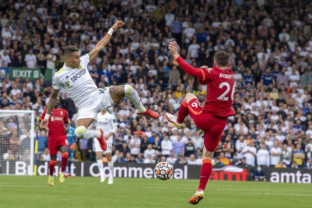 KEPT OUT: Leeds United and star winger Raphinha, left, were unable to make a breakthrough against Liverpool and Andy Robertson, right. Picture by Tony Johnson.