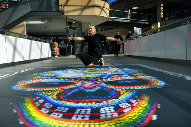 Curator Tina Ziegler with the mural art in Trinity Leeds.

Picture : Jonathan Gawthorpe