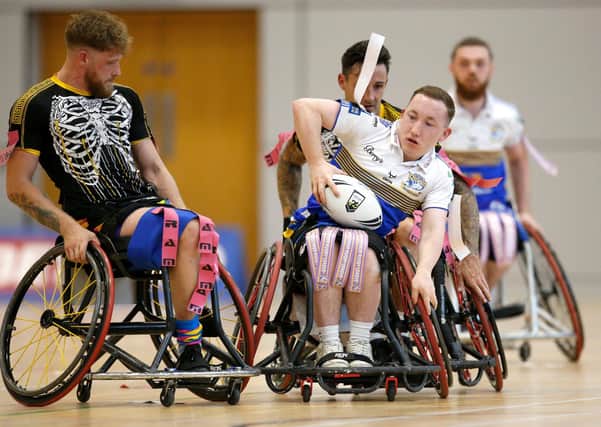 TREBLE HUNT: Leeds Rhinos' Nathan Collins battles with Argonauts Skeleton Army's Fred Nye in the Wheelchair Challenge Cup Final. Picture by Ed Sykes/SWpix.com