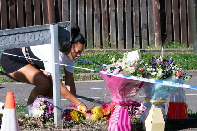 A member of the public lays flowers at the scene in Chandos Crescent, Killamarsh, near Sheffield, where four people were found dead at a house on Sunday. Derbyshire Police said a man is in police custody and they are not looking for anyone else in connection with the deaths. Picture date: Monday September 20, 2021.
PA