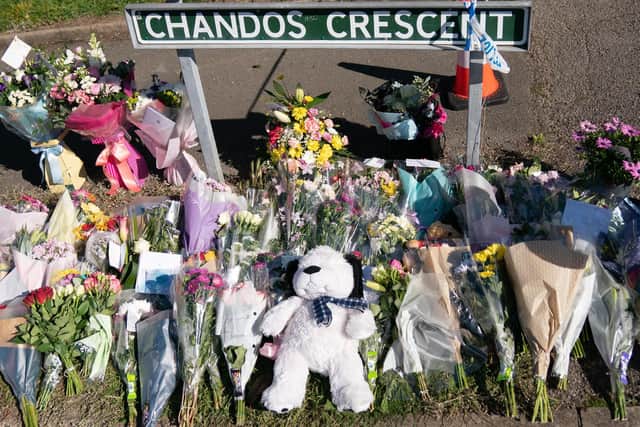 Floral tributes at the scene in Chandos Crescent in Killamarsh, near Sheffield, where four people were found dead at a house on Sunday. Derbyshire Police said a man is in police custody and they are not looking for anyone else in connection with the deaths. Picture date: Monday September 20, 2021.
PA