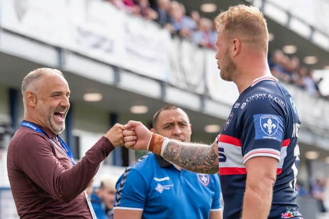 Wakefield Trinity CEO Michael Carter celebrates with loose forward Joe Westerman, with Will Poching in the background. (ALLAN MCKENZIE/SWPIX)