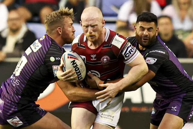 Wigan Warriors forward Liam Farrell is wrapped up by Leeds Rhinos' Matt Prior and Rhyse Martin when the sides met in the regular Super League season last month. Picture: Paul Currie/SWpix.com.