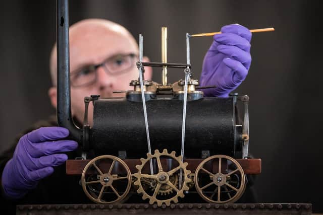 John McGoldrick, curator of industrial history at Leeds Industrial Museum, cleans the world's oldest model locomotive as it returns to the attraction. PIC: Danny Lawson/PA