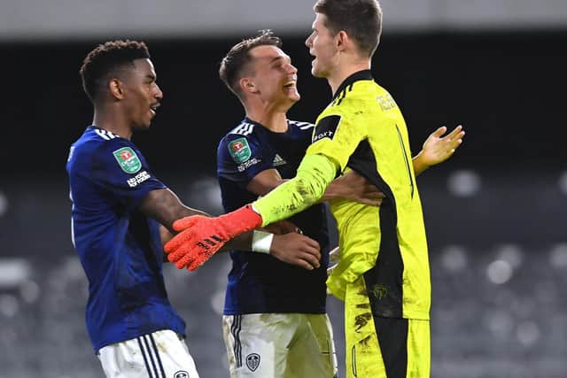 IN THE HAT: Junior Firpo, left, and Jamie Shackleton, centre, celebrate with 'keeper Illan Meslier after Leeds United's victory on penalties at Fulham in the Carabao Cup third round. Picture by Bruce Rollinson.