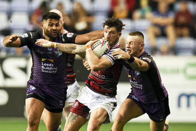 Wigan's Oliver Gildart is tackled by Leeds Rhinos' Harry Newman and Rhyse Martin in last month's Super League clash - can Rhinos win again at the DW Stadium? Picture by Paul Currie/SWpix.com