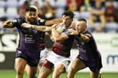 Wigan's Oliver Gildart is tackled by Leeds Rhinos' Harry Newman and Rhyse Martin in last month's Super League clash - can Rhinos win again at the DW Stadium? Picture by Paul Currie/SWpix.com