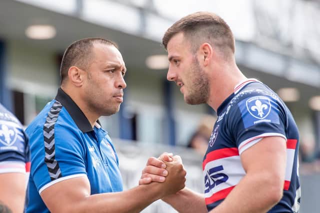 RIGHT MAN FOR THE JOB: Wakefield's interim coach Willie Poching congratulates Joe Arundel after their side's victory over Warrington Wolves Picture by Allan McKenzie/SWpix.com