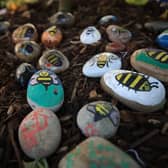 File photo dated 22/05/18 of bees painted on stones left in tribute to all the victims of the Manchester Arena terror attack placed in Manchester.
PA