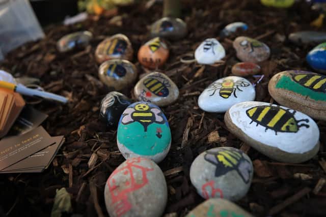 File photo dated 22/05/18 of bees painted on stones left in tribute to all the victims of the Manchester Arena terror attack placed in Manchester.
PA