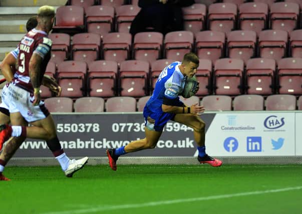 Over and out: Rhinos winger Ash Handley scores the game's only try to sink Wigan. Picture: Jonathan Gawthorpe