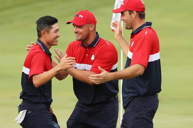 America's Collin Morikawa celebrates on the 18th green with Bryson DeChambeau and Scottie Scheffler at Whistling Straits. (Photo by Patrick Smith/Getty Images)