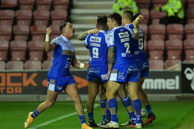Ash Handley, right, is congratulated on his try at Wigan. Picture by Jonathan Gawthorpe.