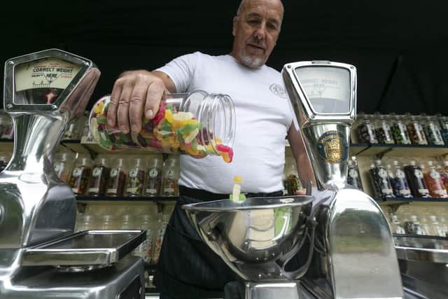 Pat Creaven, 61, weighing up sweets aboard his floating shop. Picture: Lee McLean/SWNS