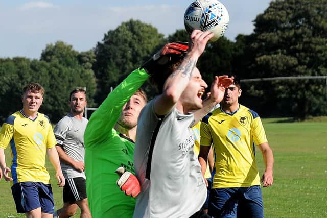 Maxillian Ballard of North Leodis is fouled by Alpha Leeds goalkeeper Joe Colley resulting in a penalty. Picture: Steve Riding.