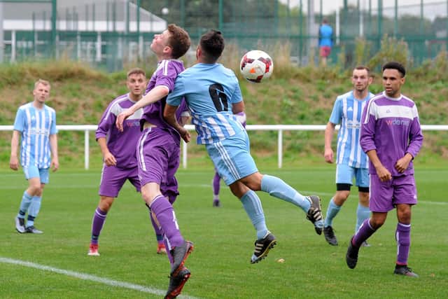 Leeds Medics and Dentists' Fraser Ritchie heads clear under pressure from Matty Dalton of Wortley. Picture: Steve Riding.