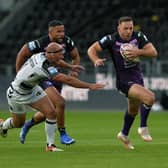 Luke Gale breaks past Danny Houghton during Rhinos' win at Hull in July. Picture by Jonathan Gawthorpe.