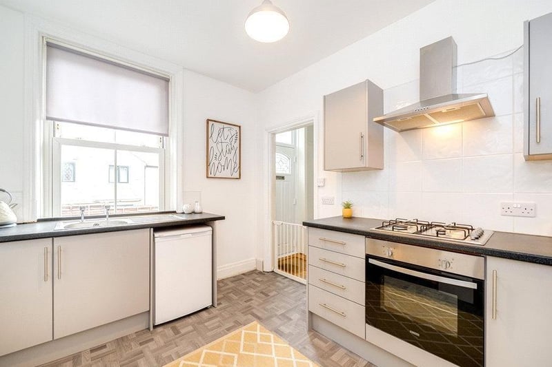 Also on this floor is the modern kitchen complete with fitted appliances. This room is  decorated in neutral tones, with grey units and black worktops.