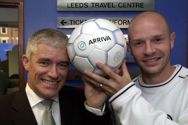 Peter Cushing and Danny Mills get their heads together to open the new travel centre at Leeds City Station.