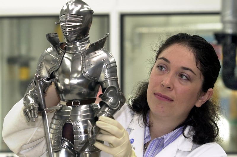 Senior conservator Suzanne Kitto cleans a miniature suit of armour ready for an exhibition at The Royal Armouries.