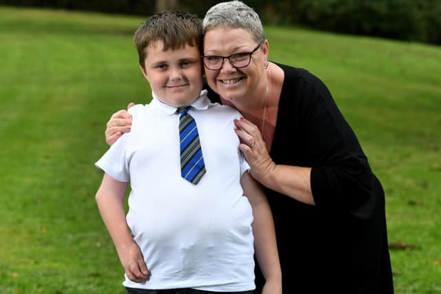 Billy Gregson - pictured with his mum Donna - is dreaming of being able to fish with his dad once he gets his new bionic arm
Pic: Simon Hulme