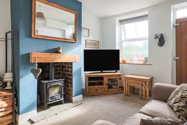 Enter into the living area, into the cosy light filled living room. The inviting room benefits from a cast iron log burning stove.