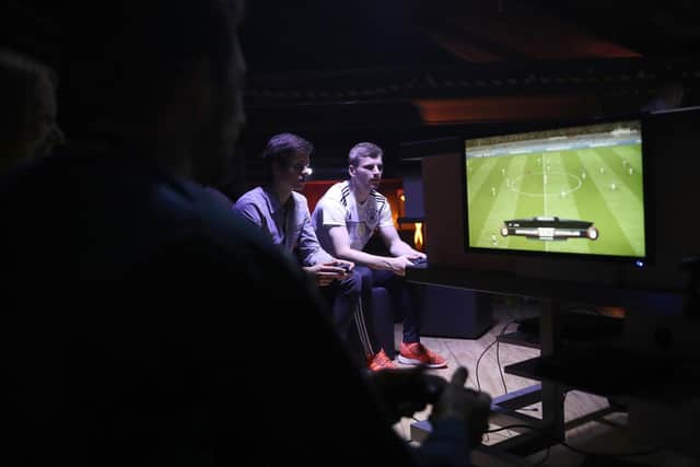 Fans play FIFA. Pic: Boris Streubel/Getty