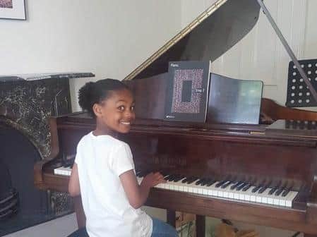 Blyss Edwards, age11, practicing before her exam in the piano practice room at Music House.