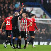 OFF: Southampton captain James-Ward Prowse, right, is show a straight red card by referee Martin Atkinson in Saturday's 3-1 defeat at Chelsea, meaning he now faces a three-game ban. Photo by Clive Rose/Getty Images.