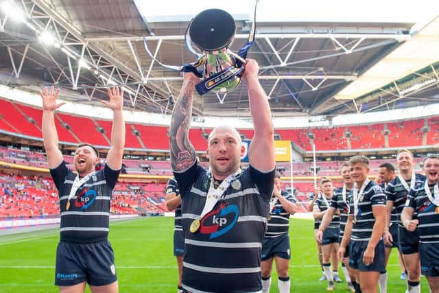 Featherstone Rovers' John Davies lifts the AB Sundecks 1895 trophy at Wembley in July. Picture: Allan McKenzie/SWpix.com.